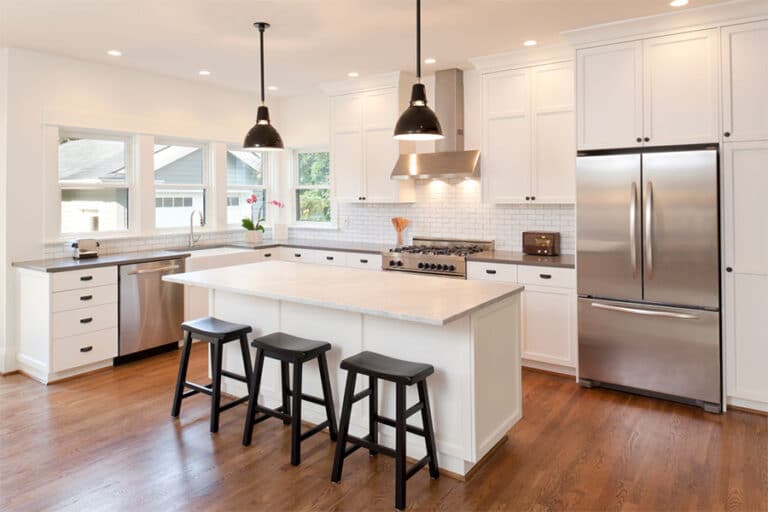 Kitchen with freshly painted white cabinets and a center island