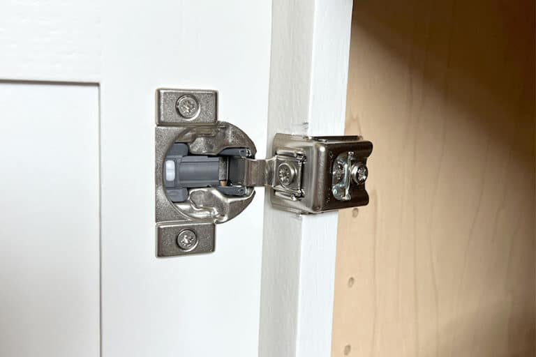 Soft close hinge on a white cabinet door